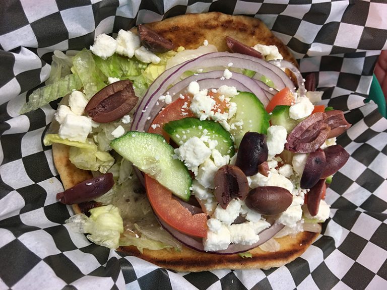 Delicious pita sandwich in a red basket.